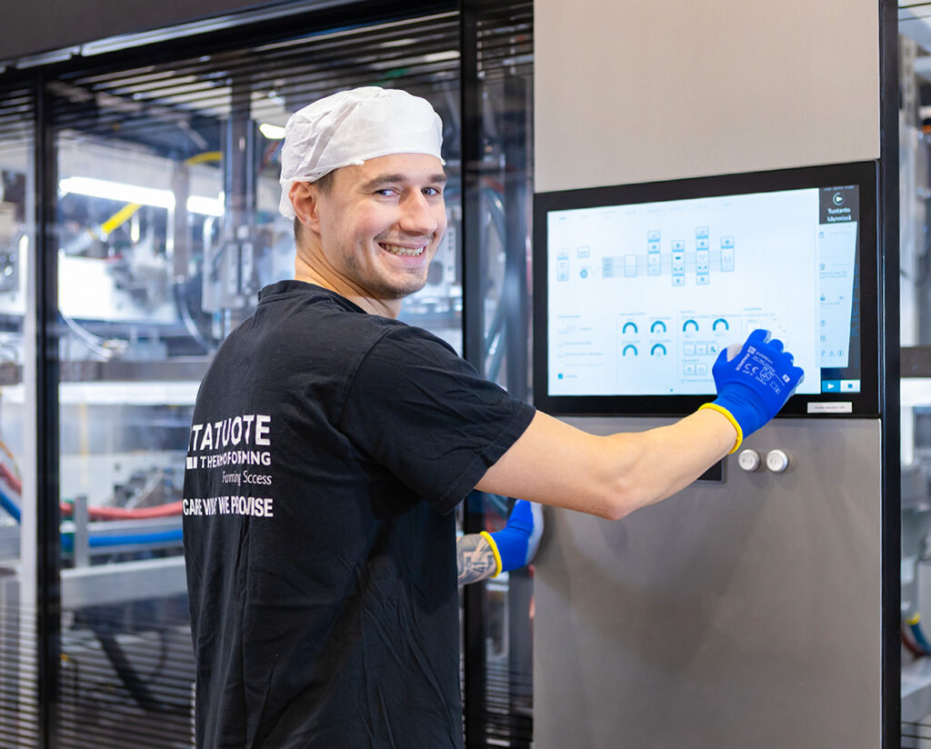 Production operator adjusting settings of a modern packaging production .