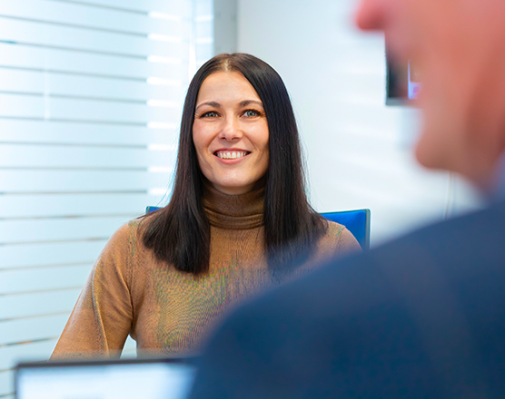 Employee working in an office, radiating positive energy.