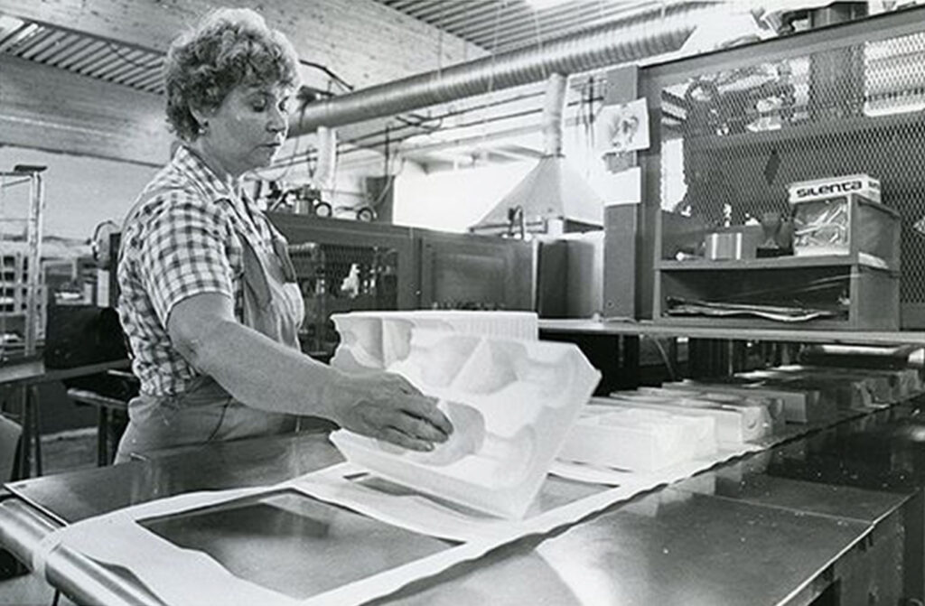 Historical image of Satatuote's employee at a production line.