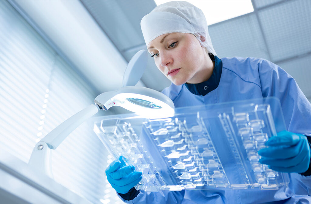 Worker ensuring quality control on a packaging production line.