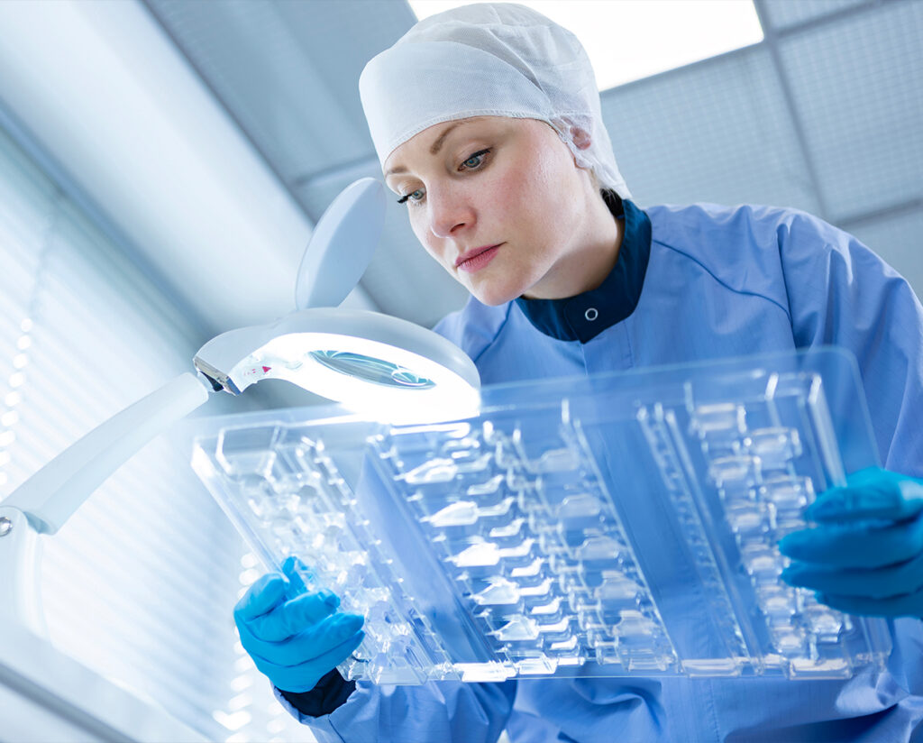 Worker ensuring quality control on a packaging production line.